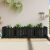 fekete tömör fenyőfa kerti magaságyás kerítéssel 200x50x50 cm